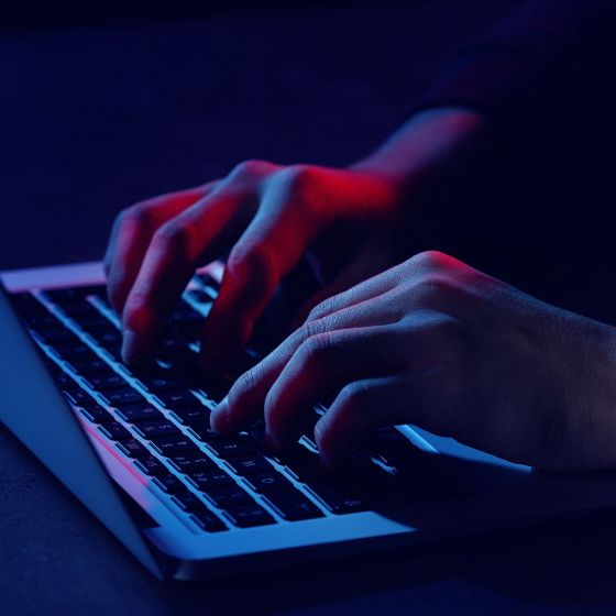 Hände tippen auf einer Laptop-Tastatur